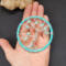 Tree is displayed in the hand to show its small size of 3 inches